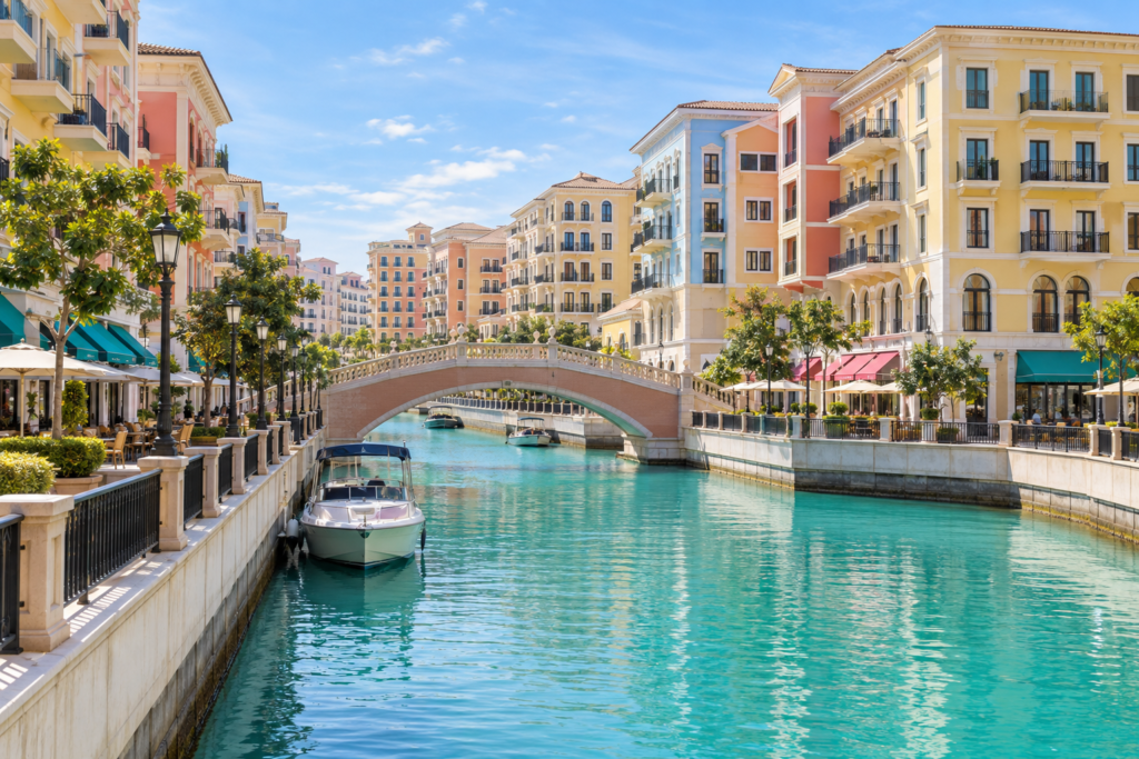 Destinations Colourful waterfront buildings and canal at Qanat Quartier in Doha